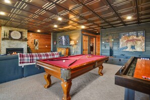 Lower level game room w/ pool table, foosball, gas fireplace
