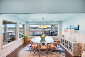 Experience the perfect gathering spot with a stunning dining room table that comfortably seats eight, all while enjoying breathtaking views of Lake Travis.