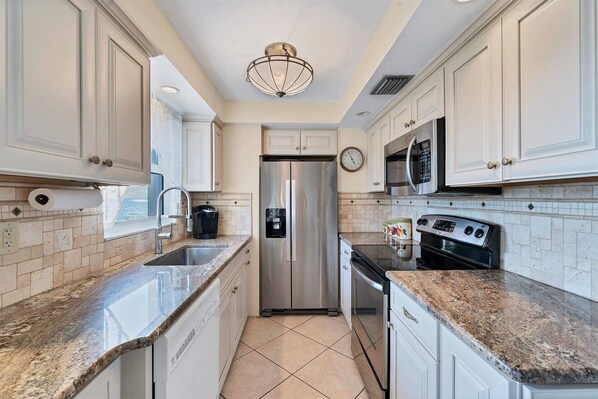 Updated kitchen includes stainless appliances and natural stone countertops.  Cook your favorite meals at home.