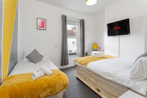 Bedroom 2 - one double and one single bed with luxury bedding and smart TV
