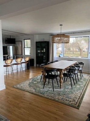 Spacious dining room with seating for 11 guests and a cozy electric fireplace.