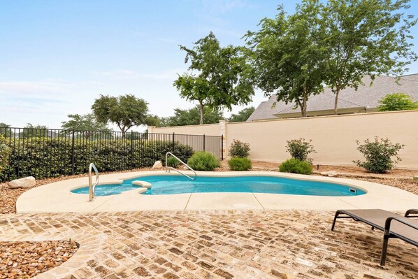 Relax and unwind by the shared poolside retreat at Gruene Silo Inn, where serenity meets sunshine for the ultimate vacation escape.