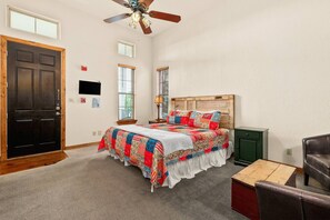 Indulge in comfort in the open suite, featuring a plush king bed, entertaining Roku flatscreen TV, and inviting sitting area.
