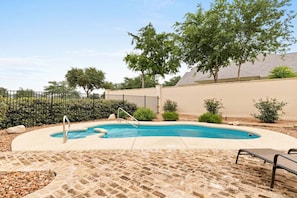 Relax and unwind by the shared poolside retreat at Gruene Silo Inn, where serenity meets sunshine for the ultimate vacation escape.