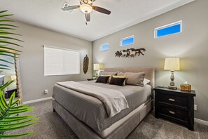 Primary bedroom has king bed, smart TV, attached bath, and large closet.