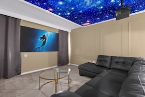 In-home movie theatre with light up ceiling.