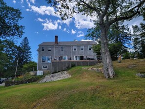 Waterside view of Cliff Cottage on Townsend Gut shows it`s on a steep incline to water