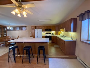 Full stock kitchen for cooking. Island w/5 bar stools. Open floor plan.