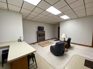 Downstairs games room with bar and tv.