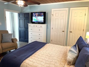 The main room has a queen bed, comfy recliners, dining area and kitchen.