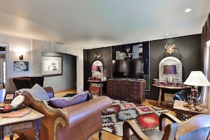 Cozy living room area with large TV and plenty of West Texas charm