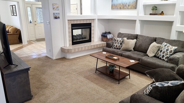 Living room - 55" TV, 2 sided fireplace, sofa & loveseat