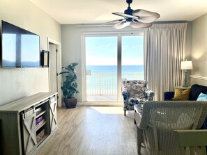 Living area with 65" TV, ocean view