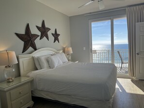 Bedroom with 55" TV, ocean view and balcony access