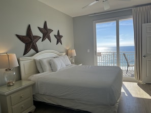 Bedroom with 55" TV, ocean view and balcony access