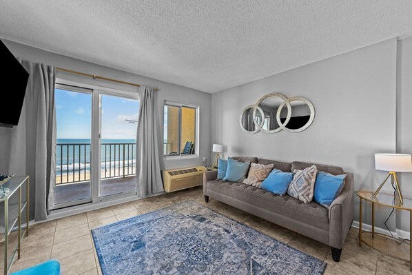Living room with private balcony overlooking the boardwalk at the oceanfront