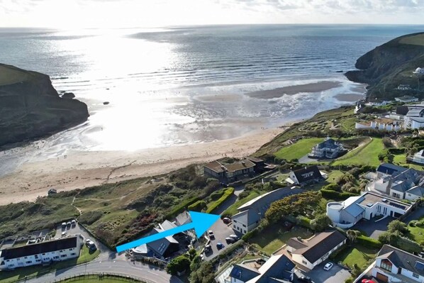 Aerial view showing White Lodge and Mawgan Porth Beach - 1 minute walk to the beach, coast path and dunes.