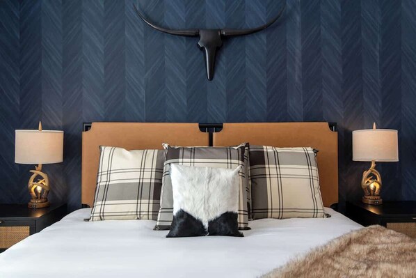 Escape to rustic elegance in our Western-style designer master bedroom.