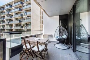 The spacious balcony is furnished with a four-seater setting and a cosy hanging pod chair where you can enjoy your morning coffee or an afternoon glass of wine. 
