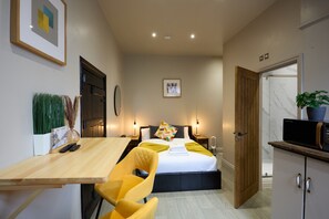 View of studio - large ottoman storage bed