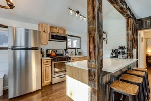 Take in the awe-inspiring beauty of the mountains as you cook in this newly remodeled cabin kitchen, featuring panoramic views right outside your window. With modern appliances, ample counter space, and a backdrop of natural beauty, you'll feel inspired to create delicious meals and unforgettable memories. Come experience the perfect blend of style, comfort, and breathtaking views.