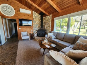 Living area with large windows for viewing the lake and a 55" Samsung HD TV