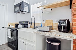 Cook with ease in a kitchen where modern appliances meet homey charm, perfect for culinary creations