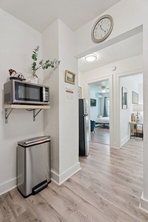 Grab a quick snack or reheat leftovers in this handy kitchenette with microwave and stainless steel trash bin.
