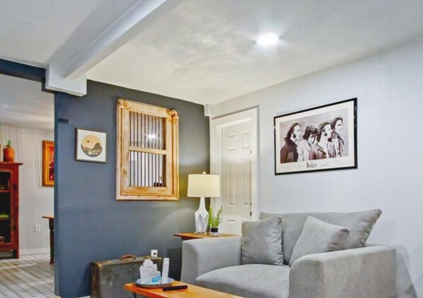 Unwind in our spacious studio, featuring a comfortable sofa and plenty of natural light. The perfect place to relax after a long day of exploring.