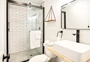 Refresh in a bathroom that’s both sleek and serene, offering a calming retreat