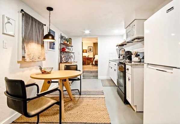 Gather in the cozy living room where every seat invites conversation and relaxation.
