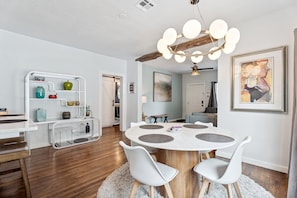Mid-century curves meet farmhouse charm—this bright dining area sets the tone for relaxed, stylish stays.