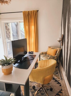 Dedicated office space with desk, monitor, swivel chair, and Wi-Fi—perfect for remote work or creative flow.