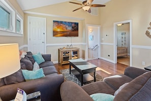 The Top-Level Living Area with a Flat Screen TV is perfect for relaxing after a day at the beach!