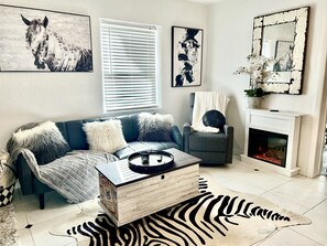 Living room with futon couch, recliner, and fireplace