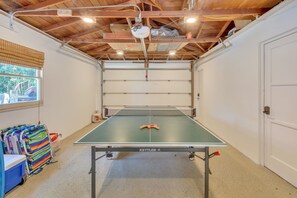 Ping pong table in the garage along with beach gear