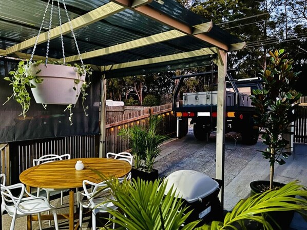 Sheltered pergola with BBQ & small car parking