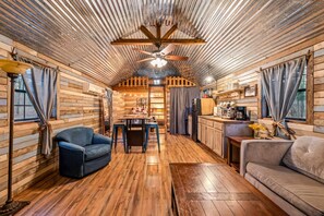 Cabin includes a (sleeper) sofa, chair, dining table, kitchen, bed, bathroom and loft area with additional sleeping.
