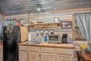 Kitchen includes a sink, toaster oven, coffee pot, microwave and more.