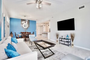 Living Room with 65" Smart TV#Disney #Parks #kingdom #springs #StoreyLake #resort #Apartment #Vacation #Rental #waterpark #Kissimmee #Orlando #universal #citywalk
