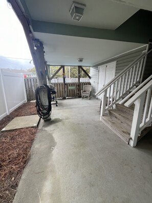 Underneath house (plenty of shade).  Grill, patio furniture & pool out back.