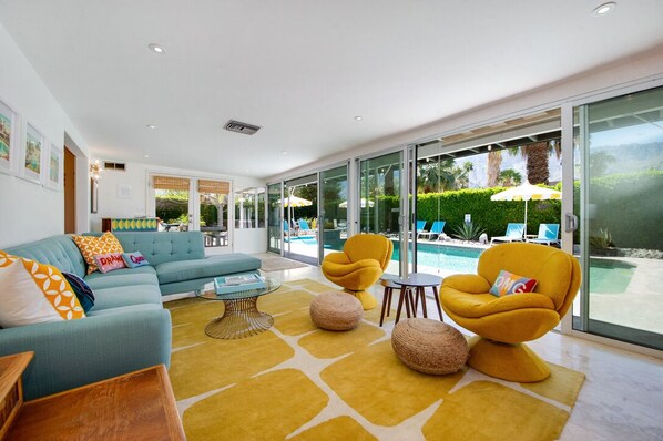 TV room with sliders that open to the pool area 
