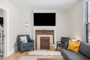 Dive into relaxation in our living room, featuring a large smart TV for your enjoyment!