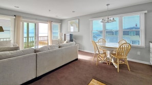 Open and bright main living area with living room, dining area and kitchen