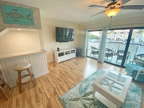 living room with bar area and flat screen tv
