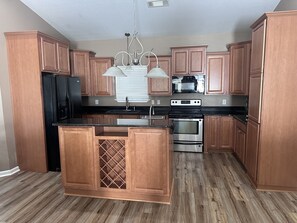 Full size kitchen with plenty of space and amenities for cooking. 