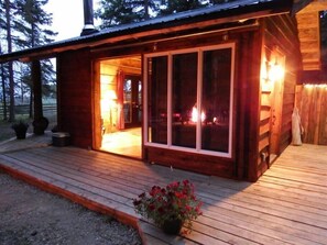 Outside Camp Fire reflecting in the sliding glass barn door