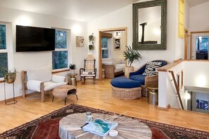 Living Room- Showing stairs that lead down to the bedrooms. We have permanently installed a safety gate for the little ones.