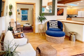 Living Room- Seating showing the rocking chair, ocersized wicker chair and white club chair.
