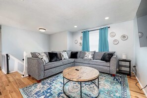  Spacious family room featuring comfortable seating with a full size pull out couch